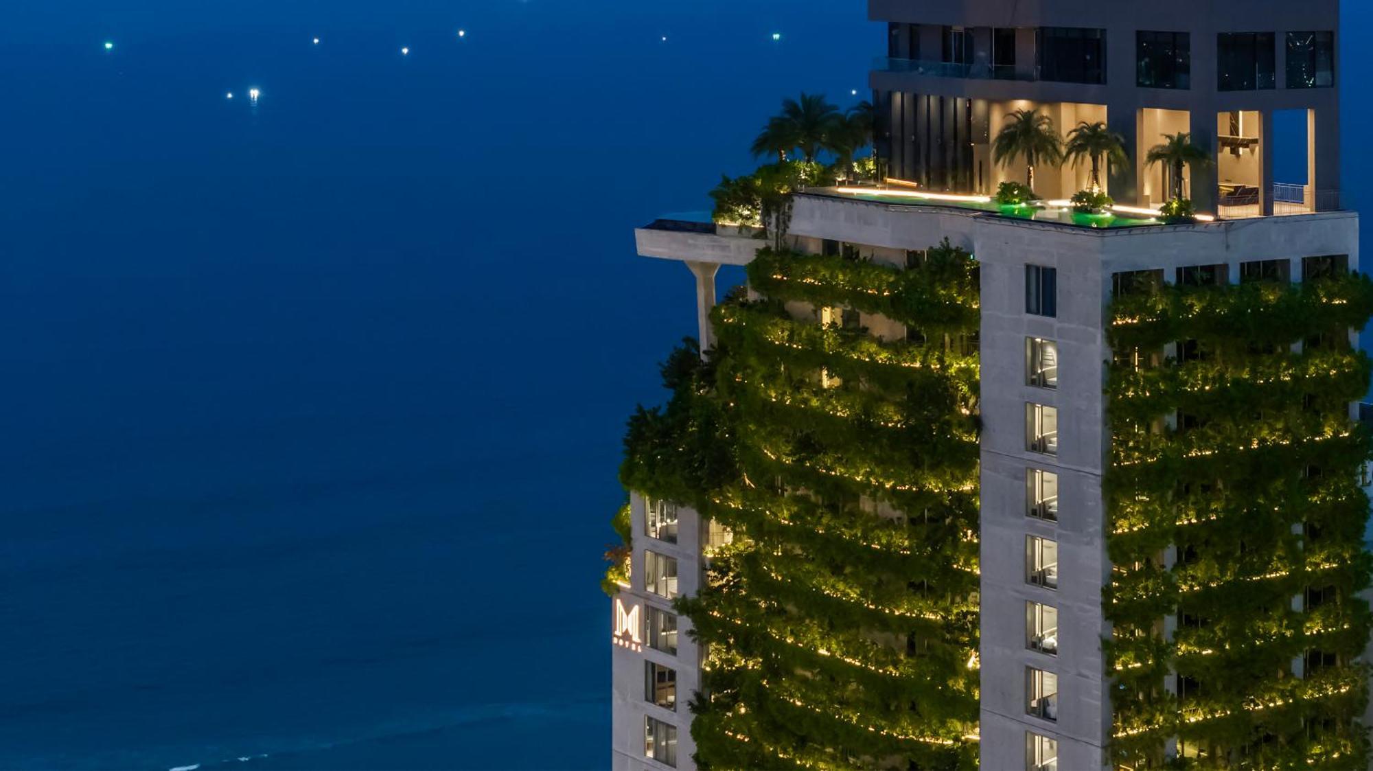 M Hotel Danang Exterior photo The vertical forest at night